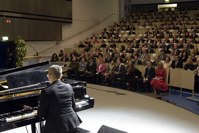  Pianist playing the grand piano on stage of Lecture hall 3A at the New Year's reception